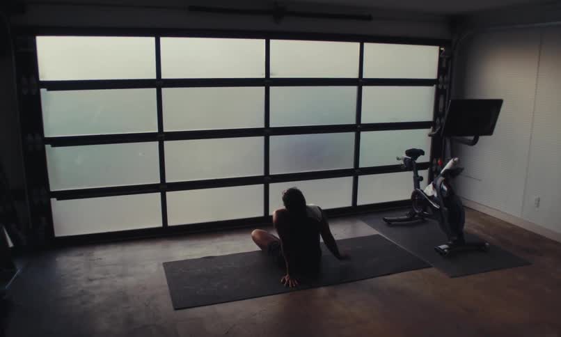 A woman is sitting and resting in the gym