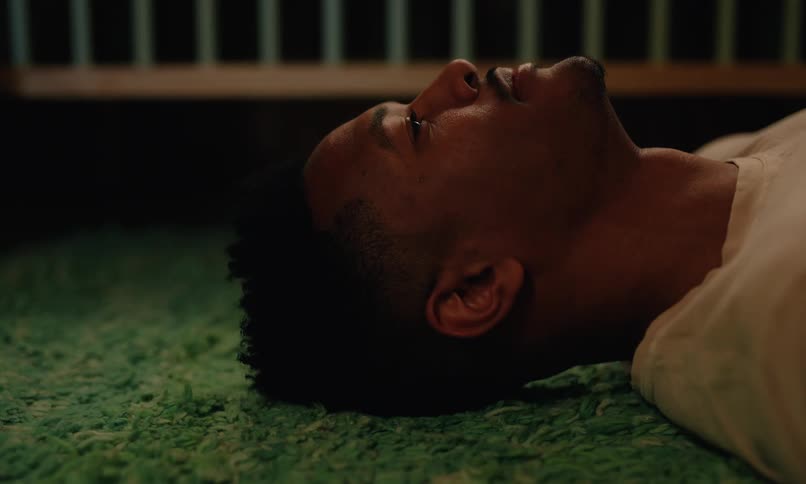 A man lays on the floor and laughs