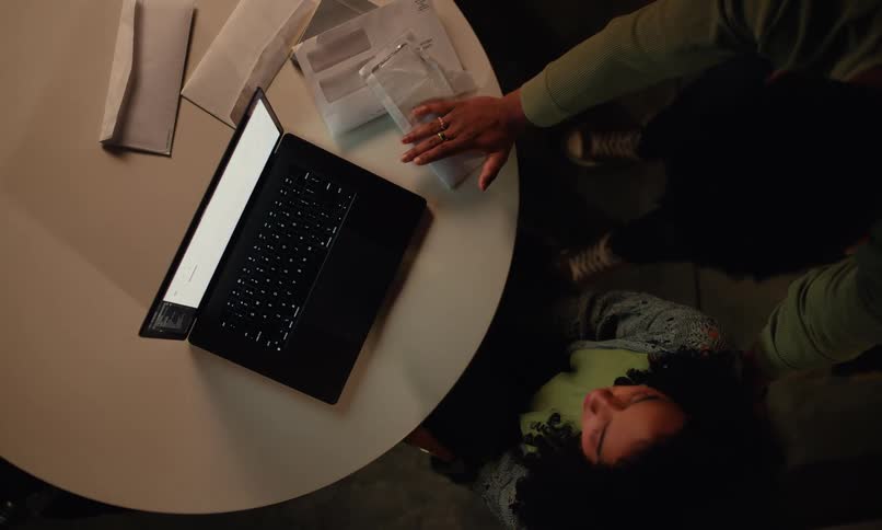 A man and woman have an argument while looking at a laptop
