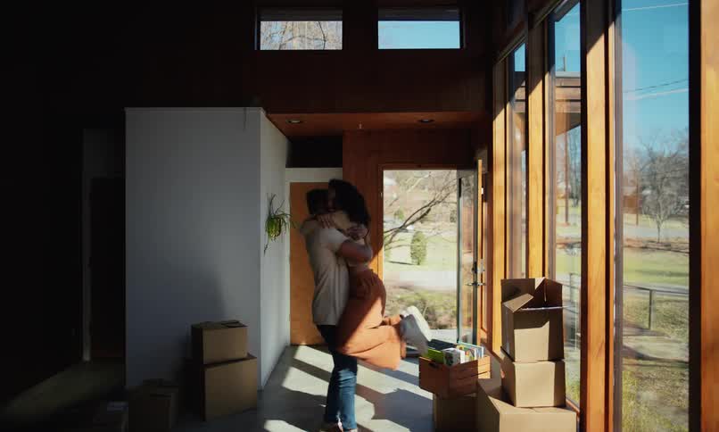 Couple hugging in new home happy and romantic