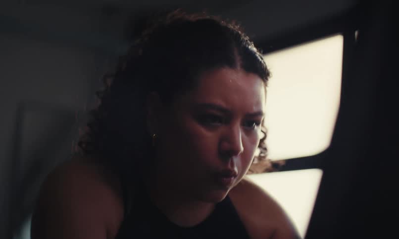 A woman is pedaling on an exercise bike