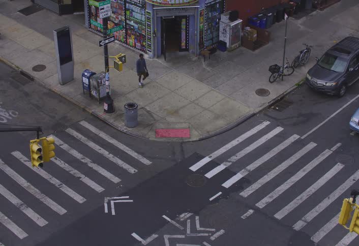 Man walking through city with vehicle traffic