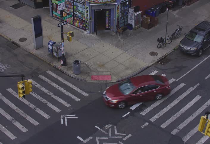 Vehicles move through an intersection in a city