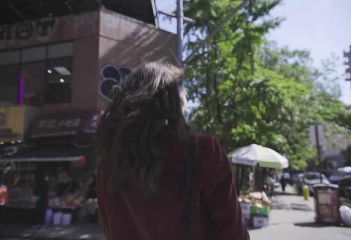 A woman walks and crosses the street