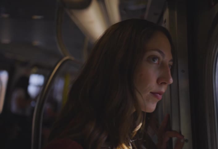 A footage of a lady in a train