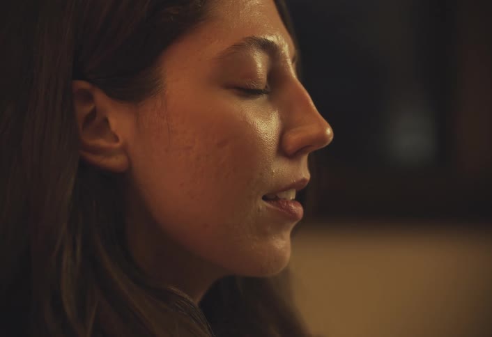 A footage of a ladys face smiling