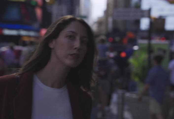 Closeup of a woman walking through a crowded city street