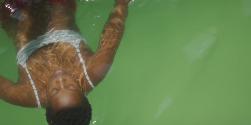 A woman does the backstroke in the pool