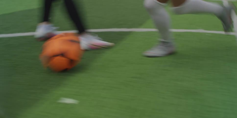 Players kick the ball on the soccer field