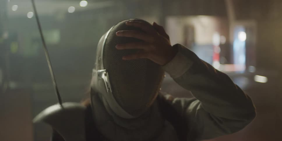 A girl is fencing in the auditorium