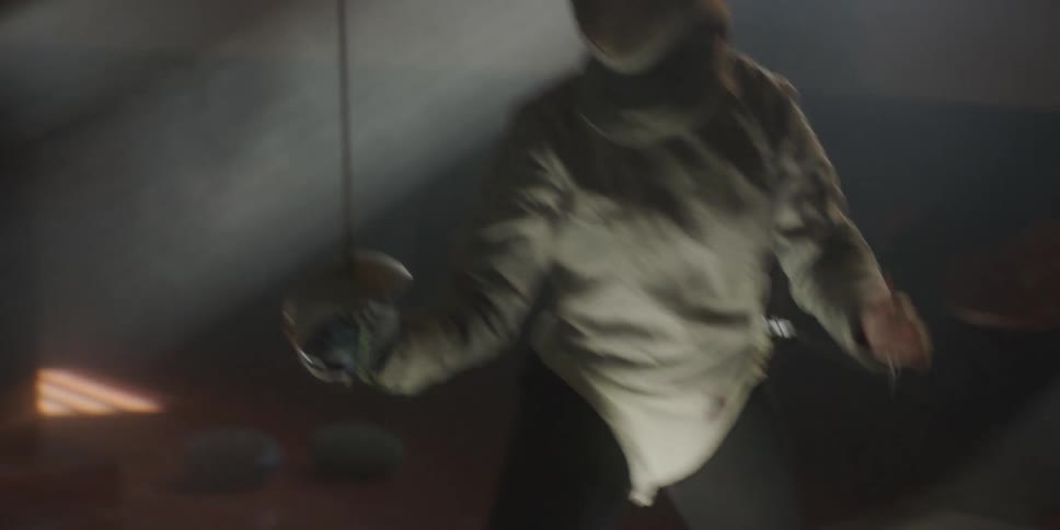 Two people are having a fencing match