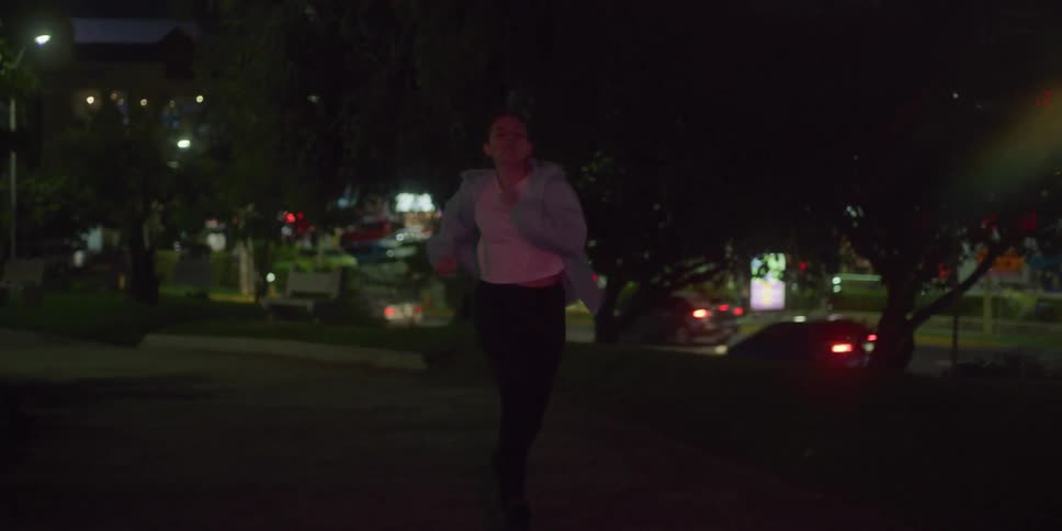 A woman is running really fast down a city road
