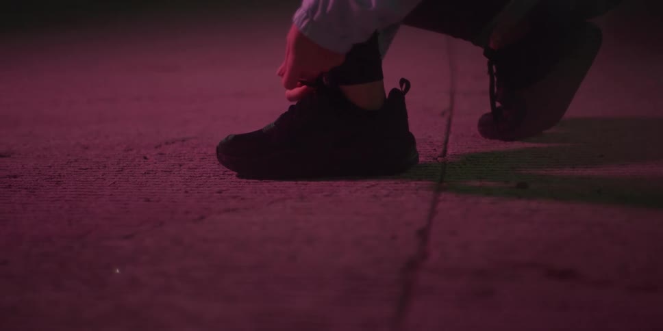 A woman tying her shoelace