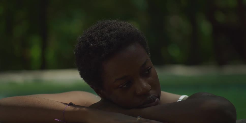 Woman on the edge of a pool looking thoughtful