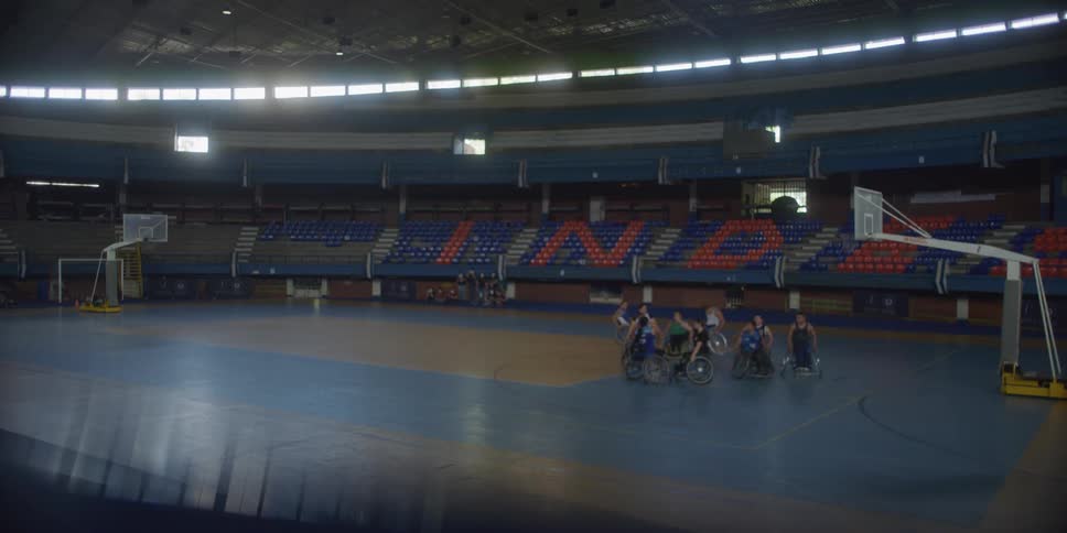 People in wheelchairs are playing a game of basketball