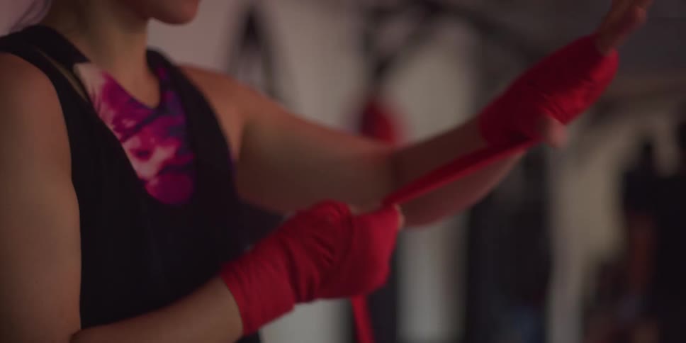 Woman putting a red band on her hands