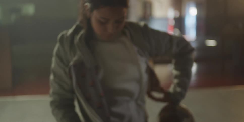 Woman putting on fencing equipment