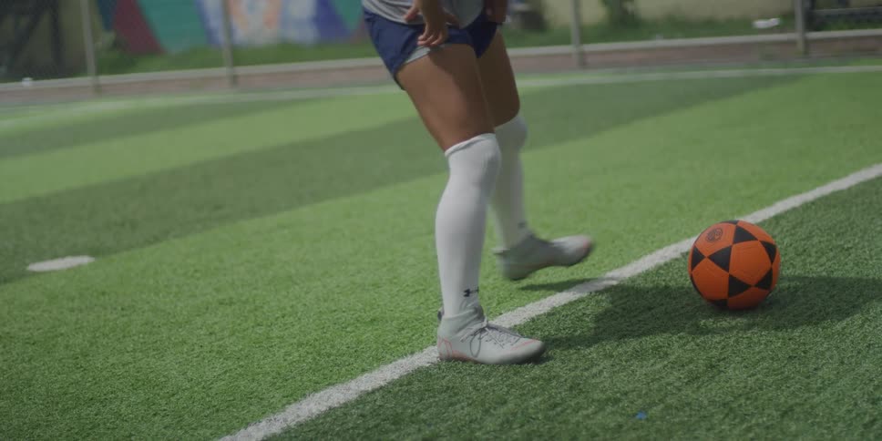 Woman stretching to play soccer