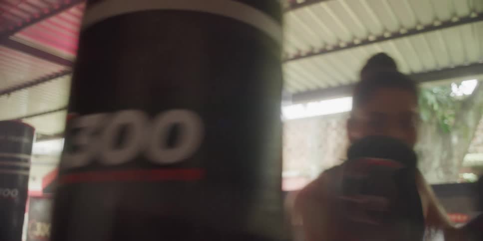 Woman with gloves punching a punching bag