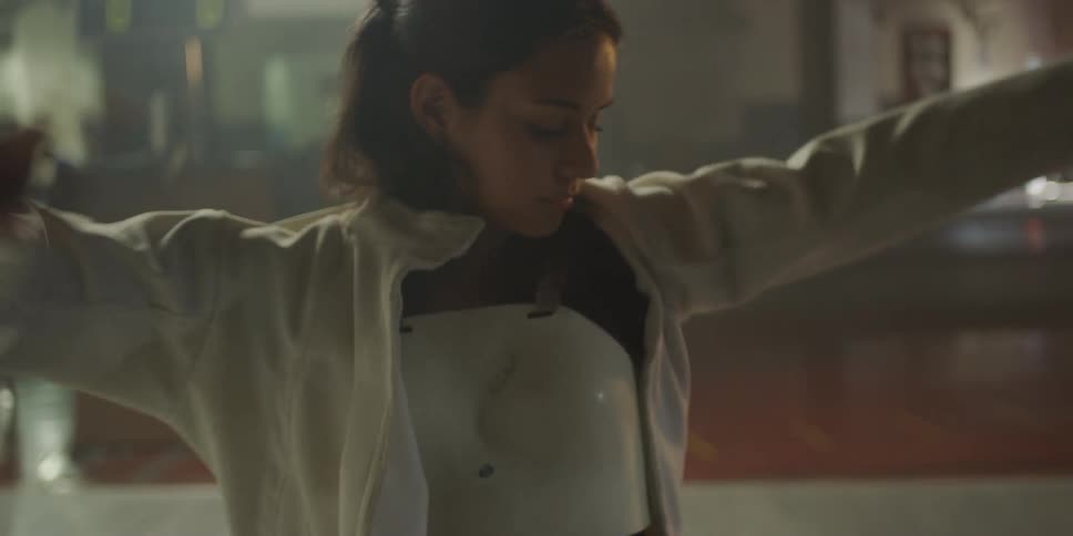 Woman in a gym putting on protective clothing