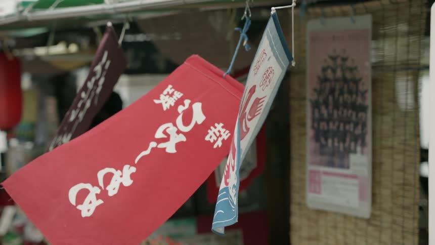 The signs blow in the wind in front of a shop