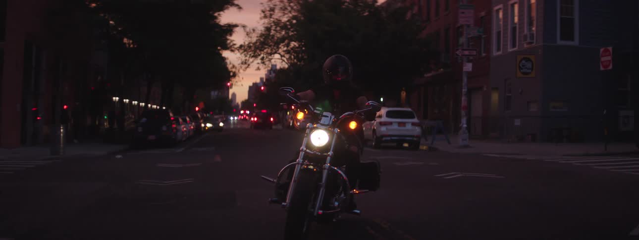 A man drives on the rode past the apartments