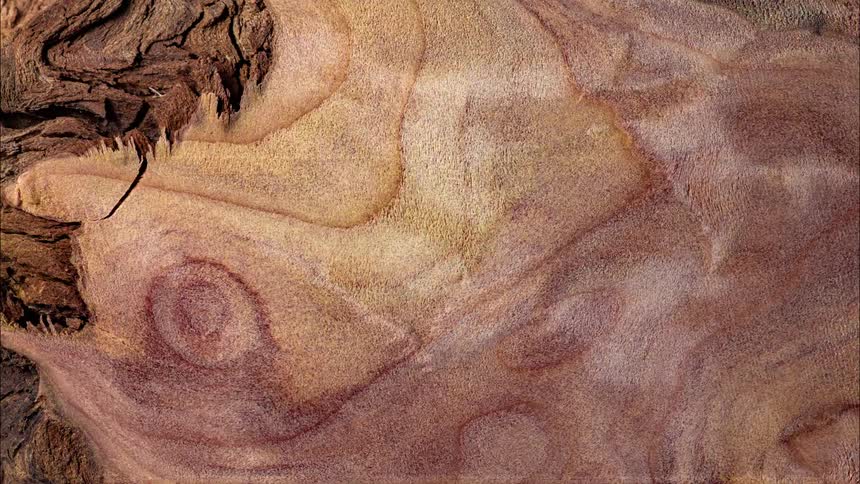 Sandy mixture flows like water over a textured area creating cracks in the surface