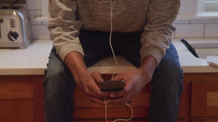 Pair of hands of a person interacting with a smartphone