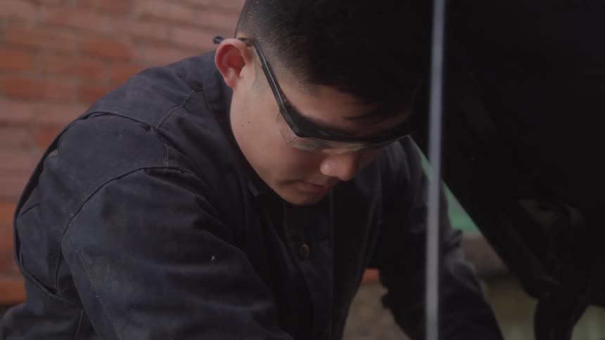 A mechanic looks at a car