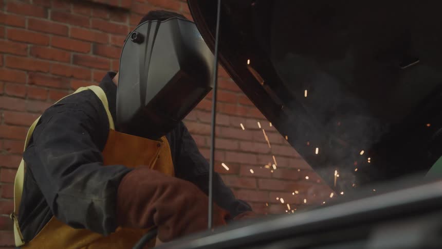 A mechanic works on a car