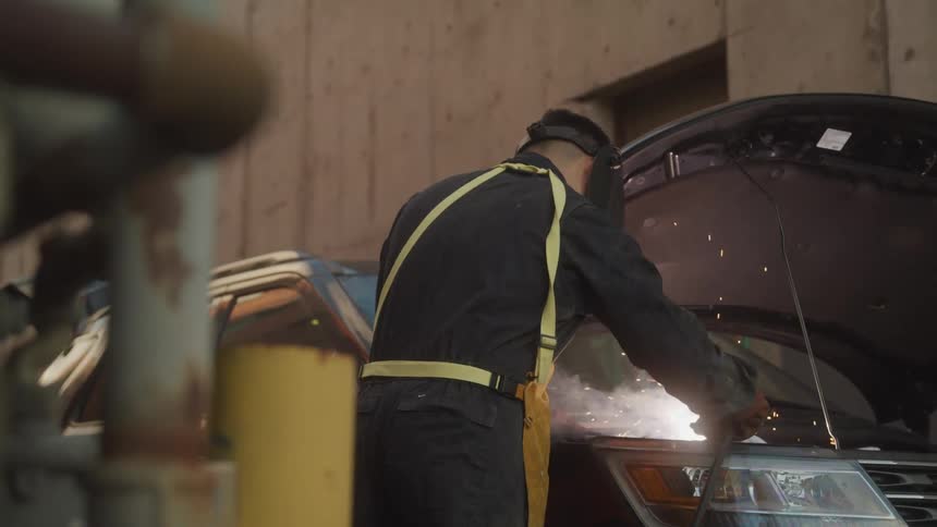 A mechanic works on a car