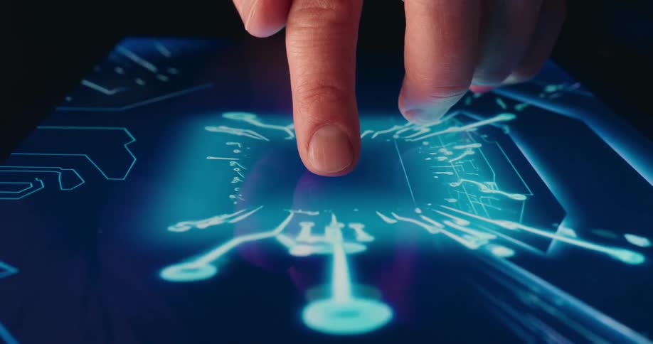 Finger touching a digital surface with electronic circuits illuminated in blue