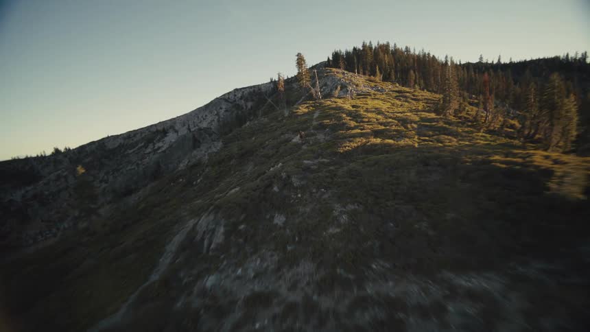 A man is running downhill on the mountain