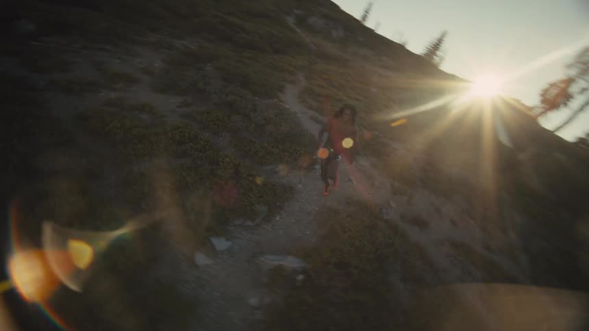 Aerial view of a man running on a mountain trail