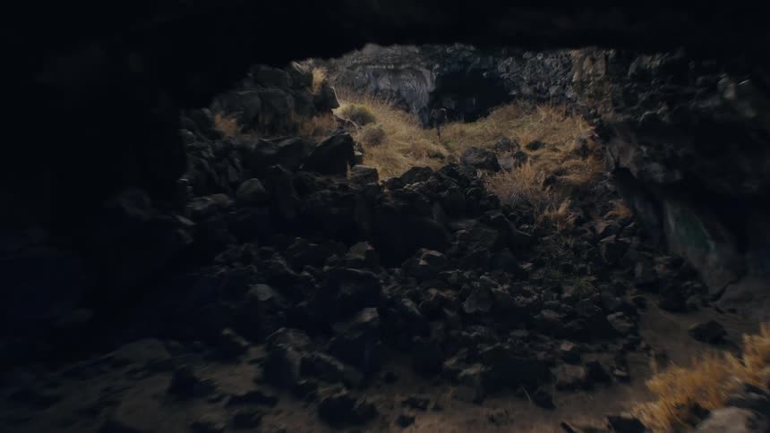 Person running between mountains and caves