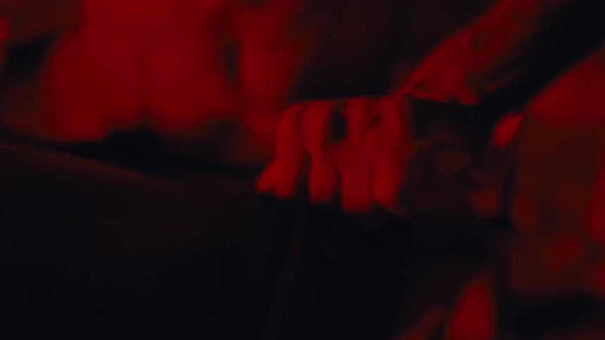 A man is working out under a red light