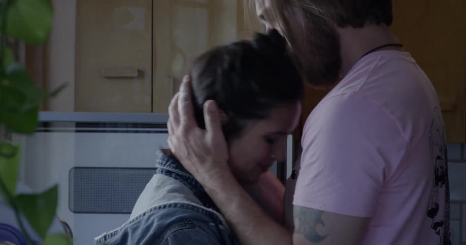 Man hugging a sad woman