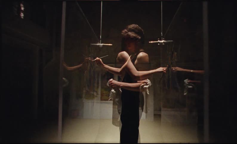 A man standing drawing on a glass and is in multiple exposure