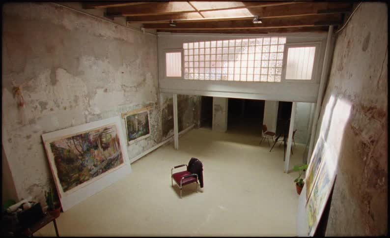 A man sitting on a chair appearing and disappearing quickly