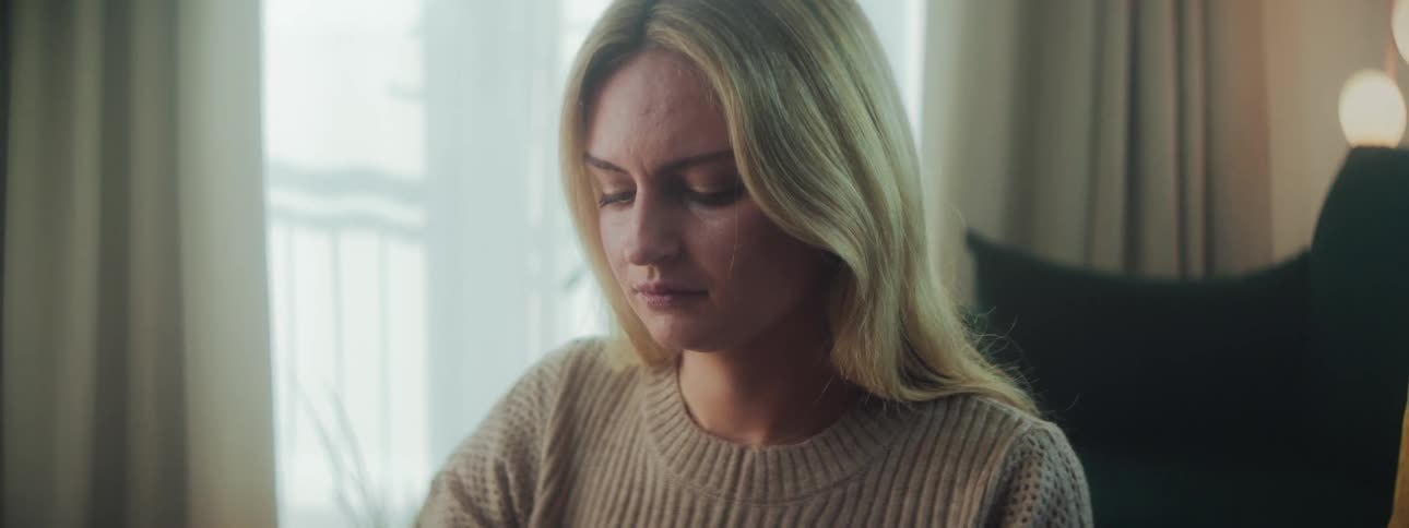 Woman in a room with a concentrated expression