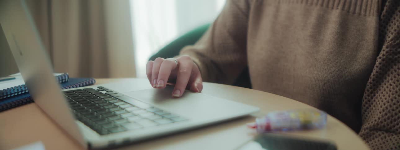 Hands of a person typing on a laptop