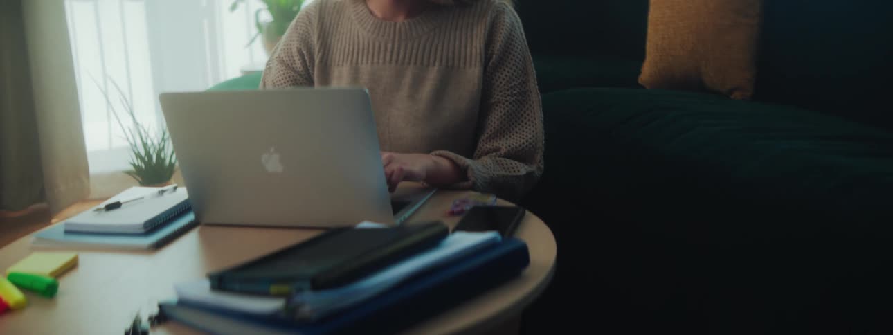 Woman sitting working on a laptop