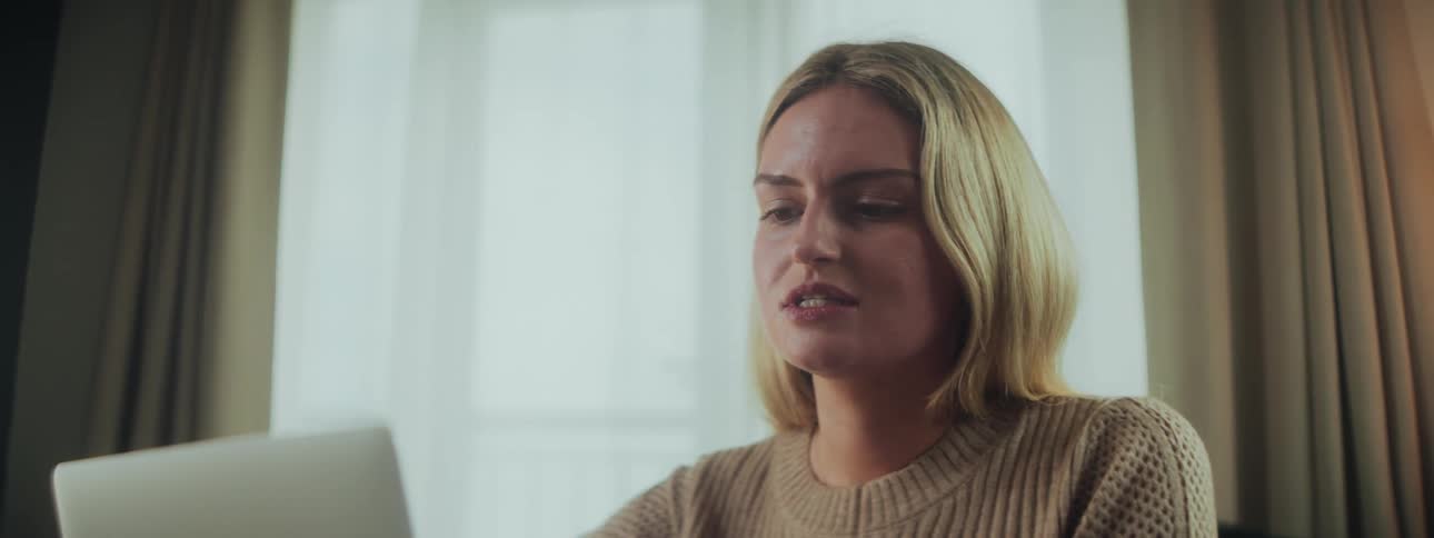 Blonde woman indoors concentrating