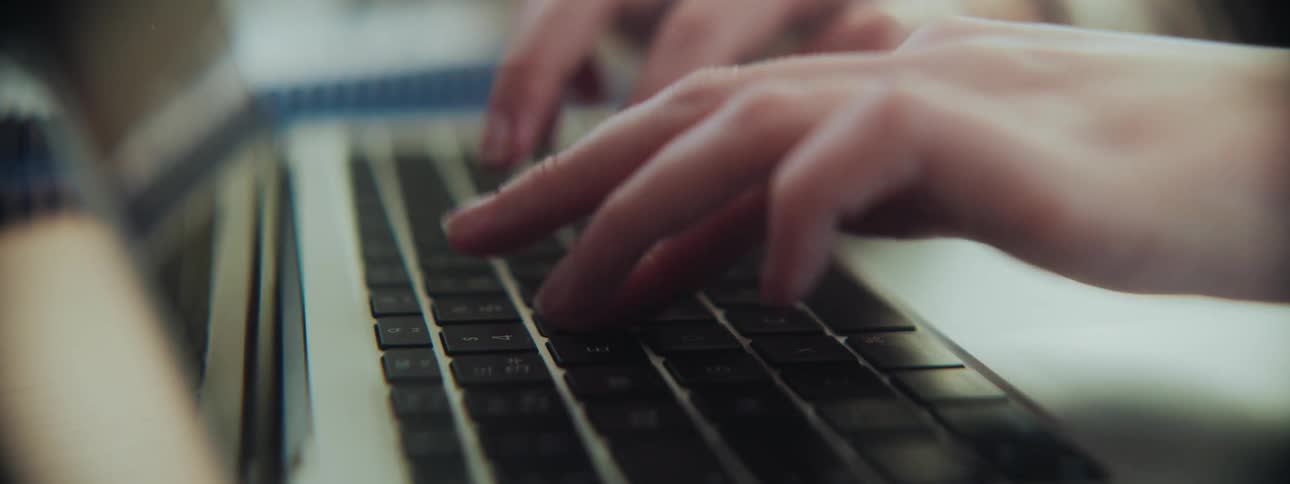 A person is typing on a laptop