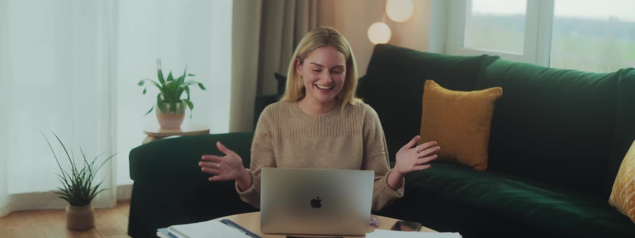 Happy woman in a meeting talking in front of a laptop
