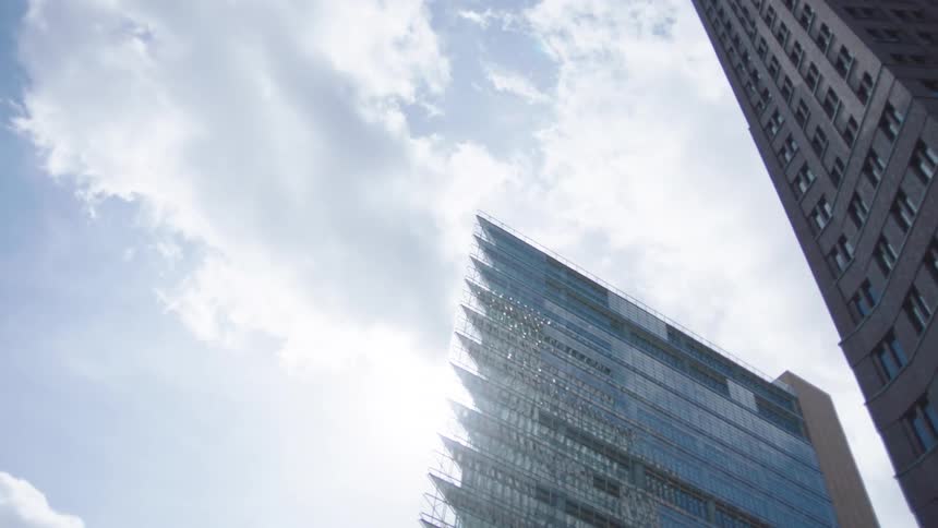 Skyscrapers in the metropolis with one glass building displaying a sharp point for an edge