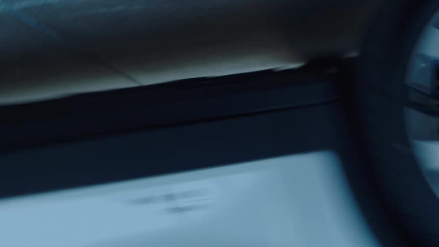 A white car in motion at an airport