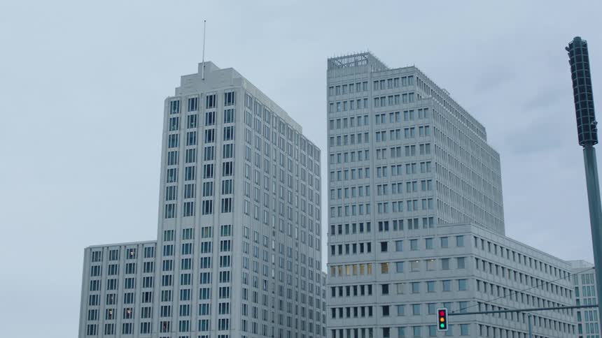 Two tall buildings and a traffic light