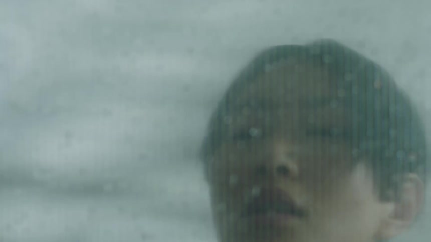 A man leans by the window