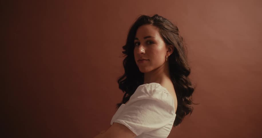 A woman is modeling in a white blouse